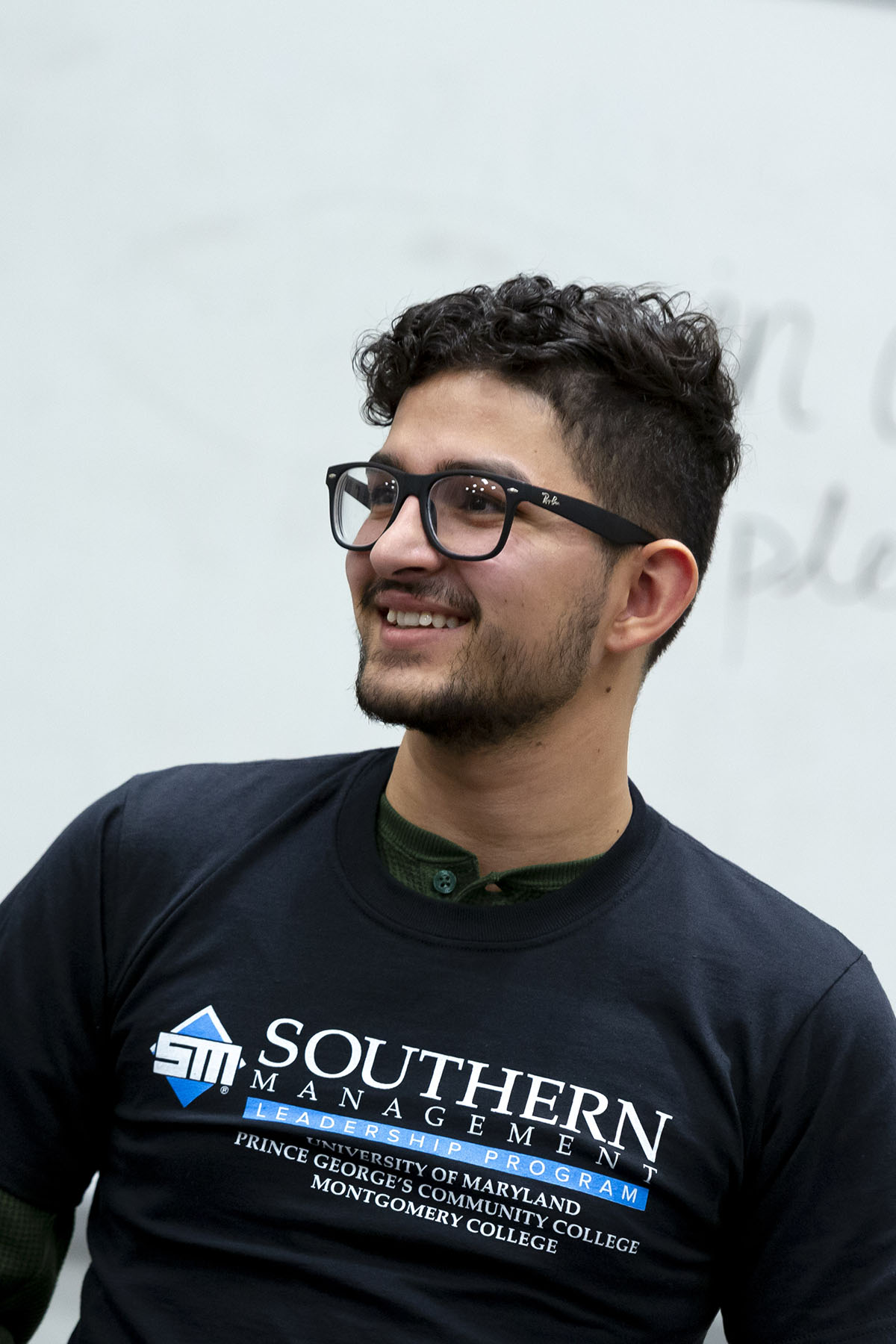 man with glasses and SMLP shirt smiling